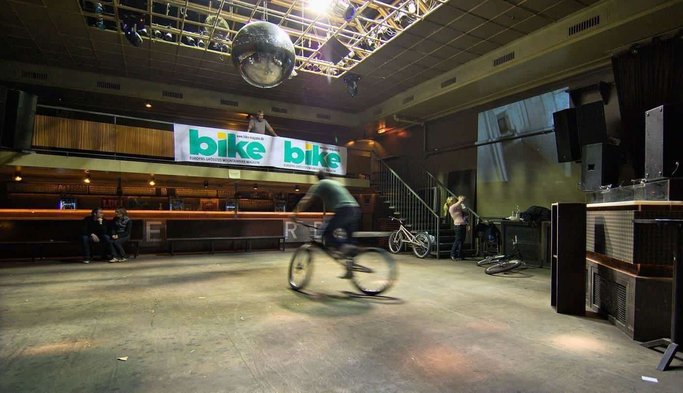 A large, empty nightclub hall with a smooth concrete floor
