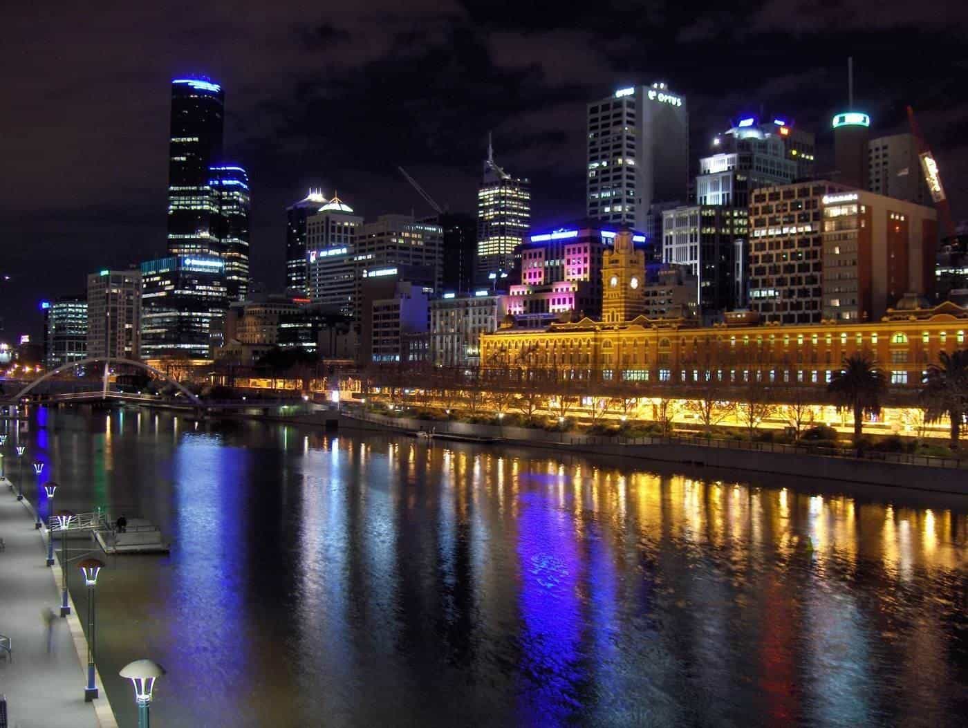 The Melbourne city skyline lit up at night across the river